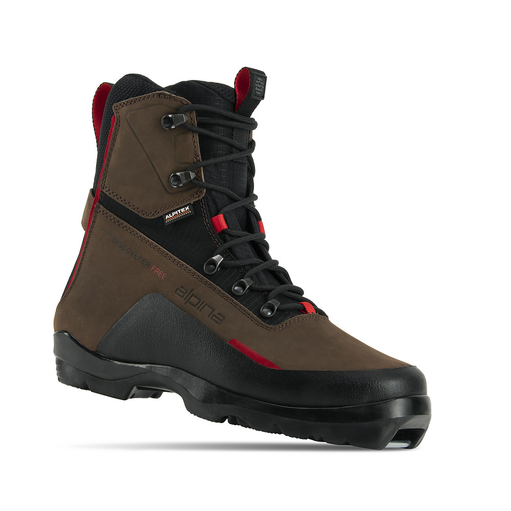 Alpina Discoverer Free backcountry ski boot, built for off-track touring in winter conditions. The brown and black high-cut boot features a water-resistant ALPITEX membrane, padded ankle support, red highlights, and a grippy outsole. Designed for warmth, comfort, and freedom of movement on rugged terrain.