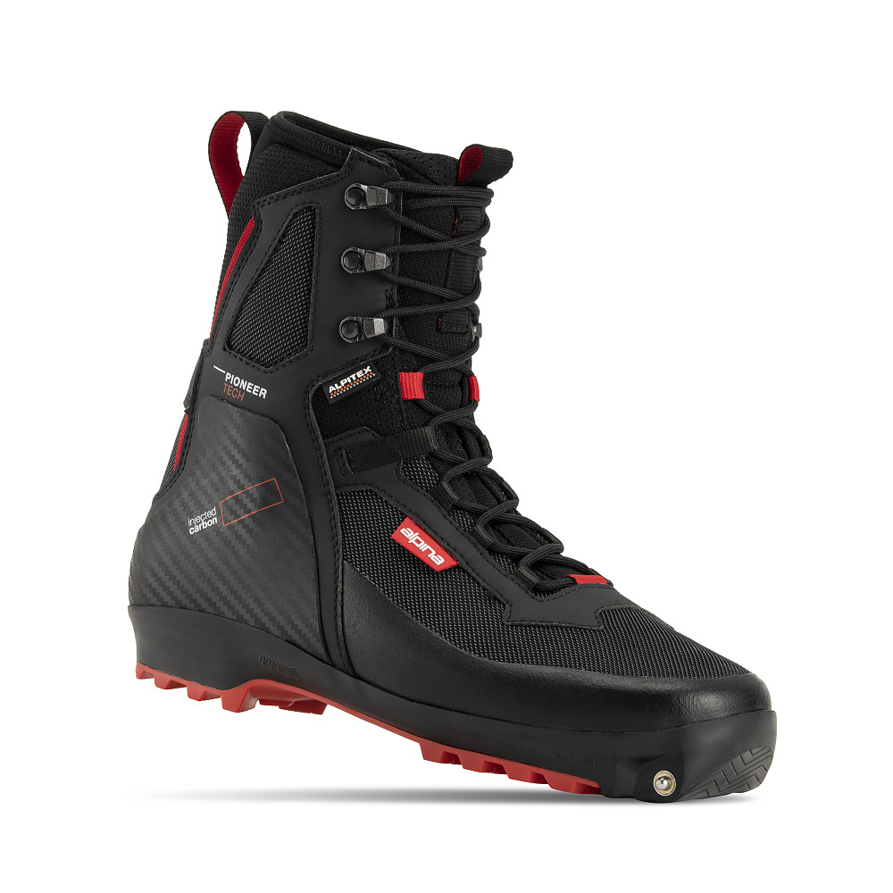 Alpina Backcountry ski boot, designed for off-track cross-country skiing in extreme conditions. The black and red boot features a high ankle, injected carbon heel support, red tread sole, and flexible rear section with added comfort zones. Durable, water-resistant, and insulated for rugged terrain and harsh weather, with red accents highlighting key functional elements.