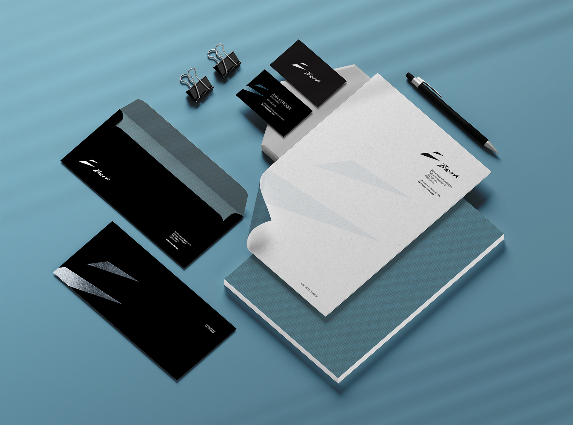 A modern brand identity for Berk Composites, featuring sleek stationery including business cards, envelopes, and letterhead. The design uses a minimal black and white color palette with sharp geometric shapes derived from the letter “B,” reflecting the brand’s refined and high-performance aesthetic. A subtle background pattern made of repeating triangular logo elements evokes the texture of carbon fibre, reinforcing the brand’s connection to premium carbon components. The composition highlights the company’s new visual direction: Lightweight Performance, Sharpened Identity.
