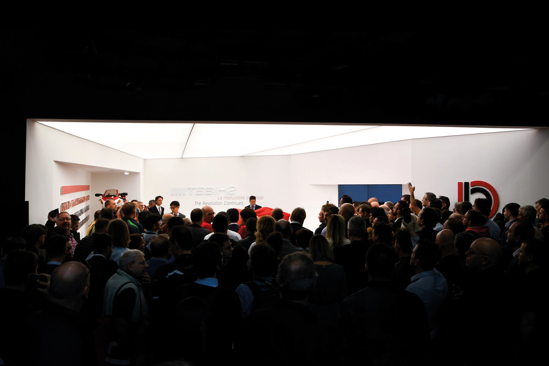A photo of the Bimota stand at Eicma show 2019 in Milano, showing the crowd gathered for the new motorcycle presentation.