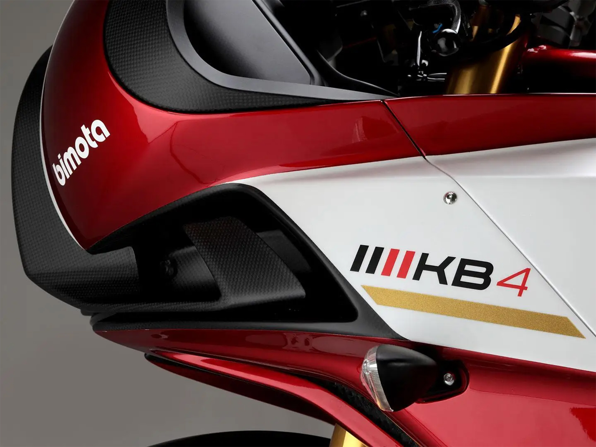 A photo of the Bimota KB4 motorcycle decal showing the side panel with the model name graphics.