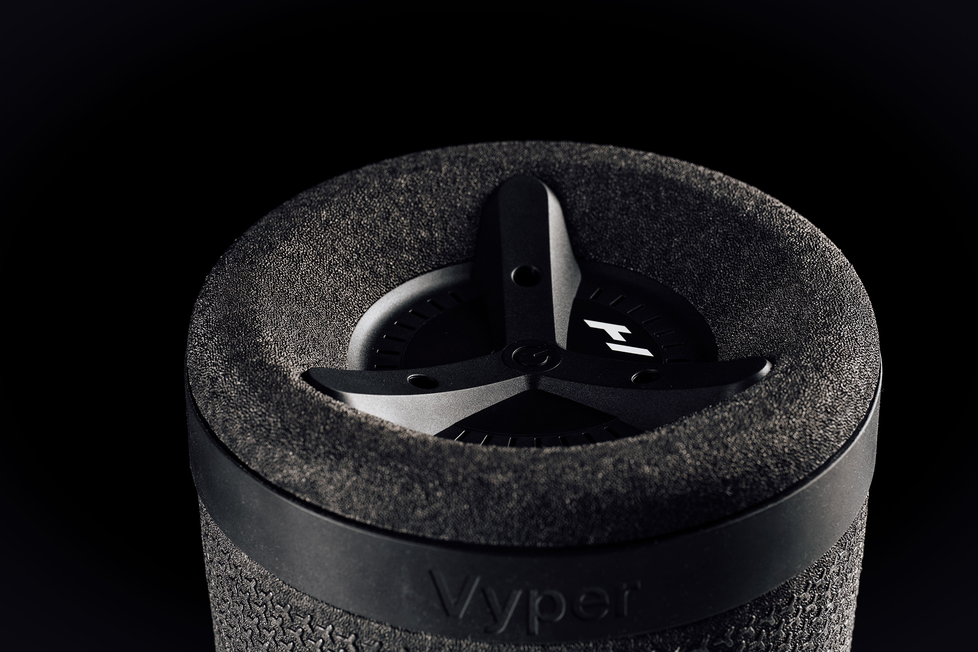 Detail photo of the Hyperice Vyper 3 massage foam roller, showing the end of the roller with the anti-slip rubber band and the end plate with interface.