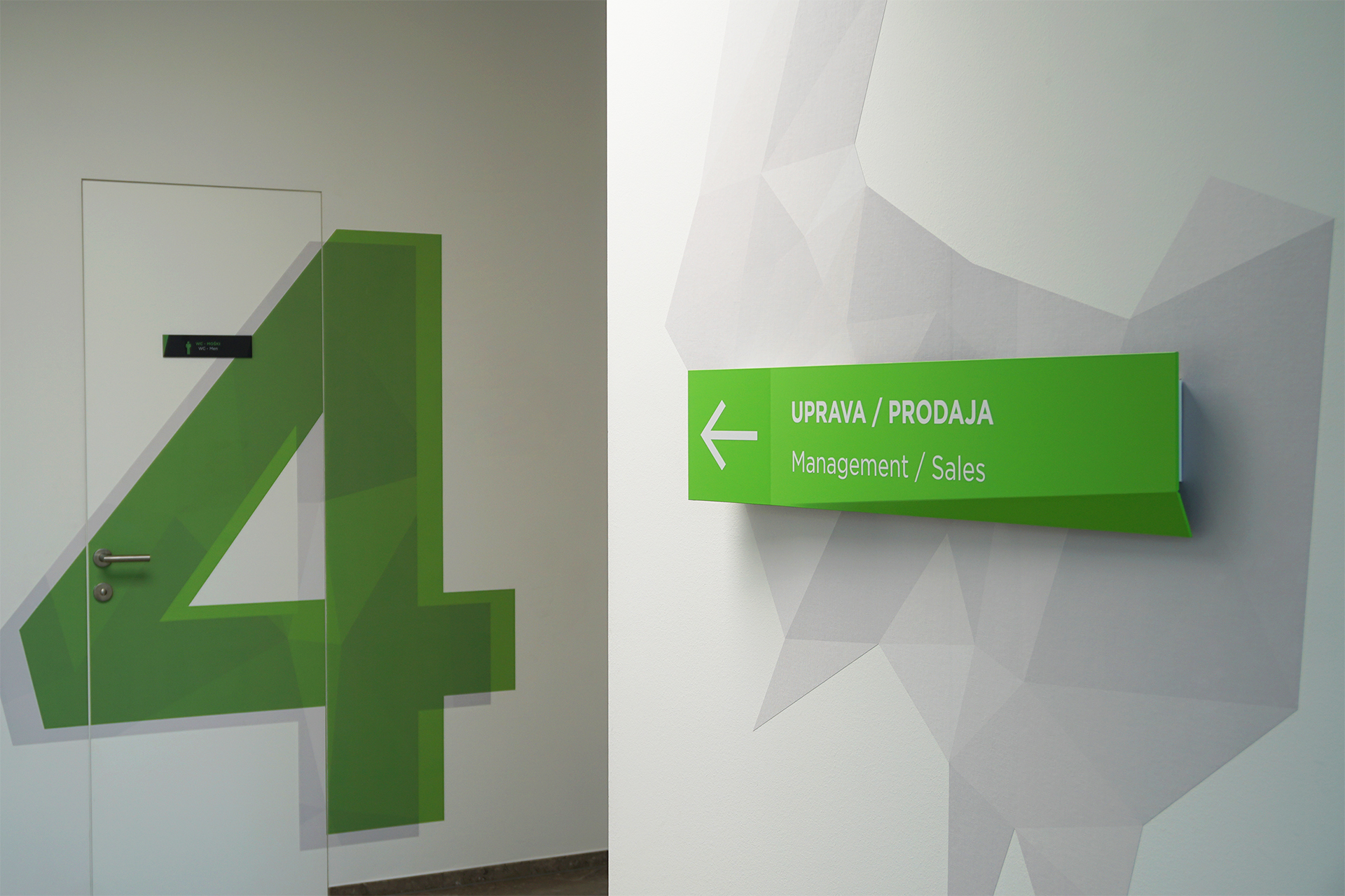 A photo of the Mebor company office space interior design, showing the custom decorative wall graphics and infographics signage.