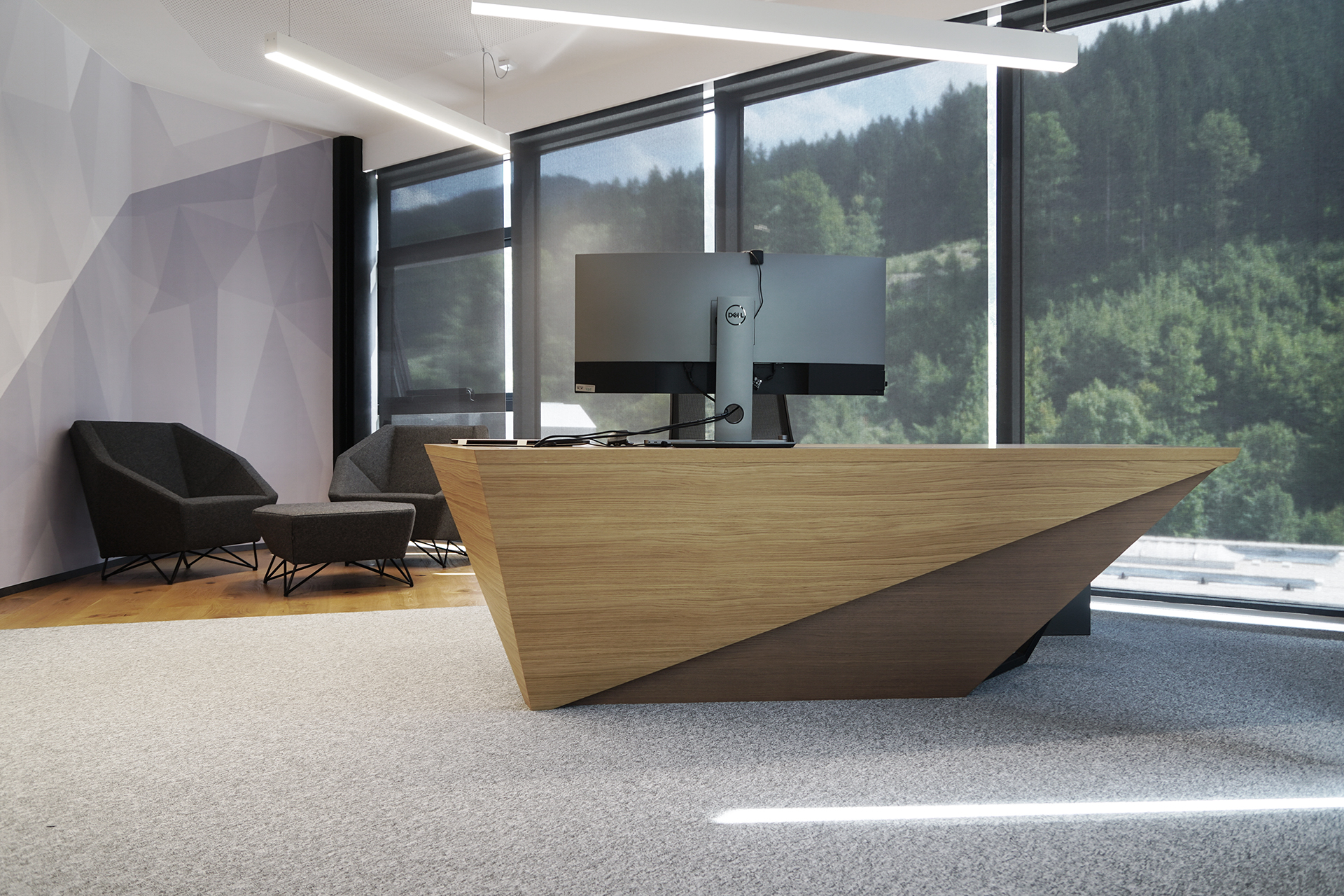 A photo of the Mebor company executive office space interior design, showing the custom executive desk and lounge area in the back.