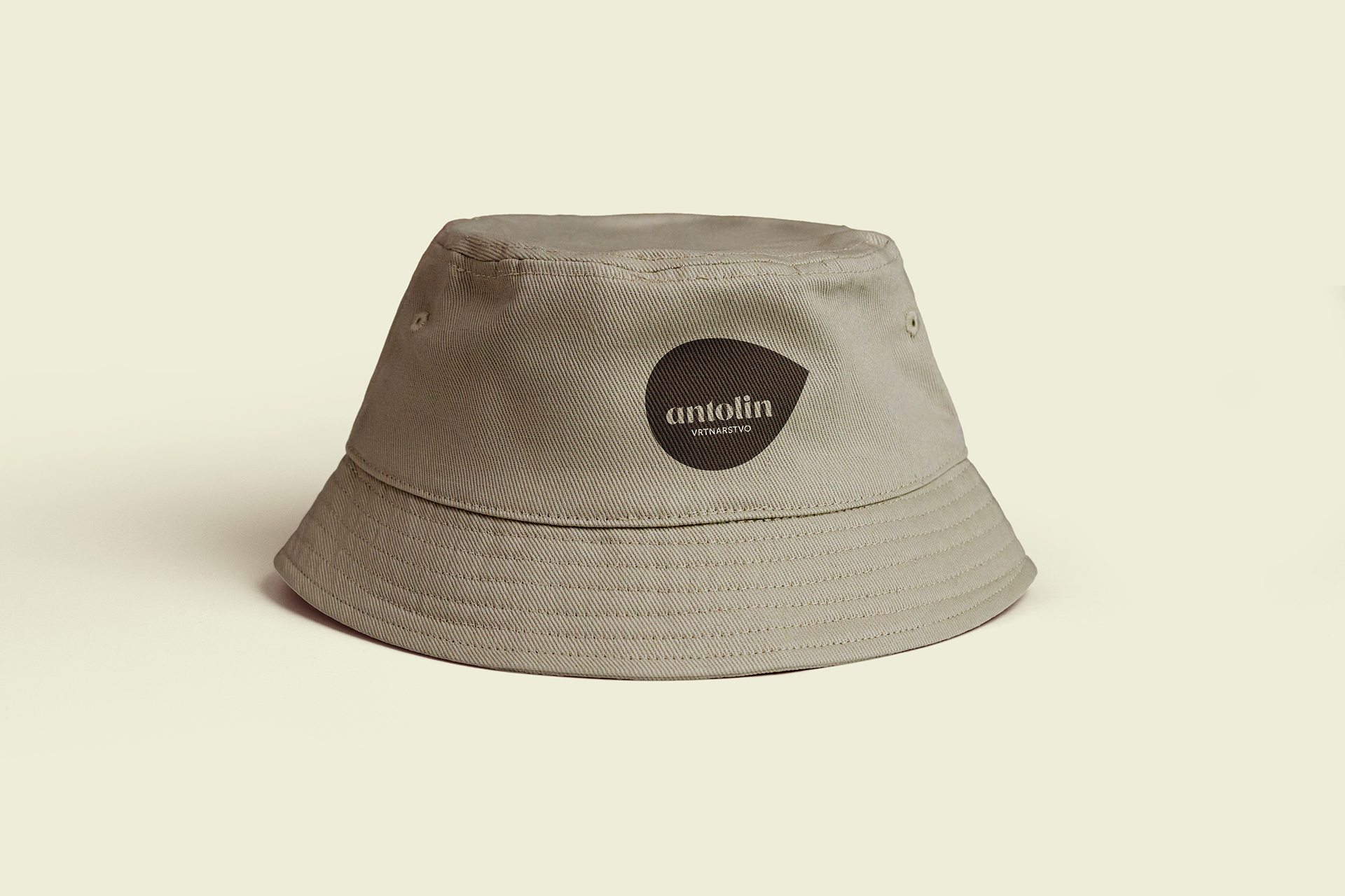 Visualisation of the Vrtnarstvo Antolin corporate brand identity design use case, showing a branded bucket hat example with Antolin logo.