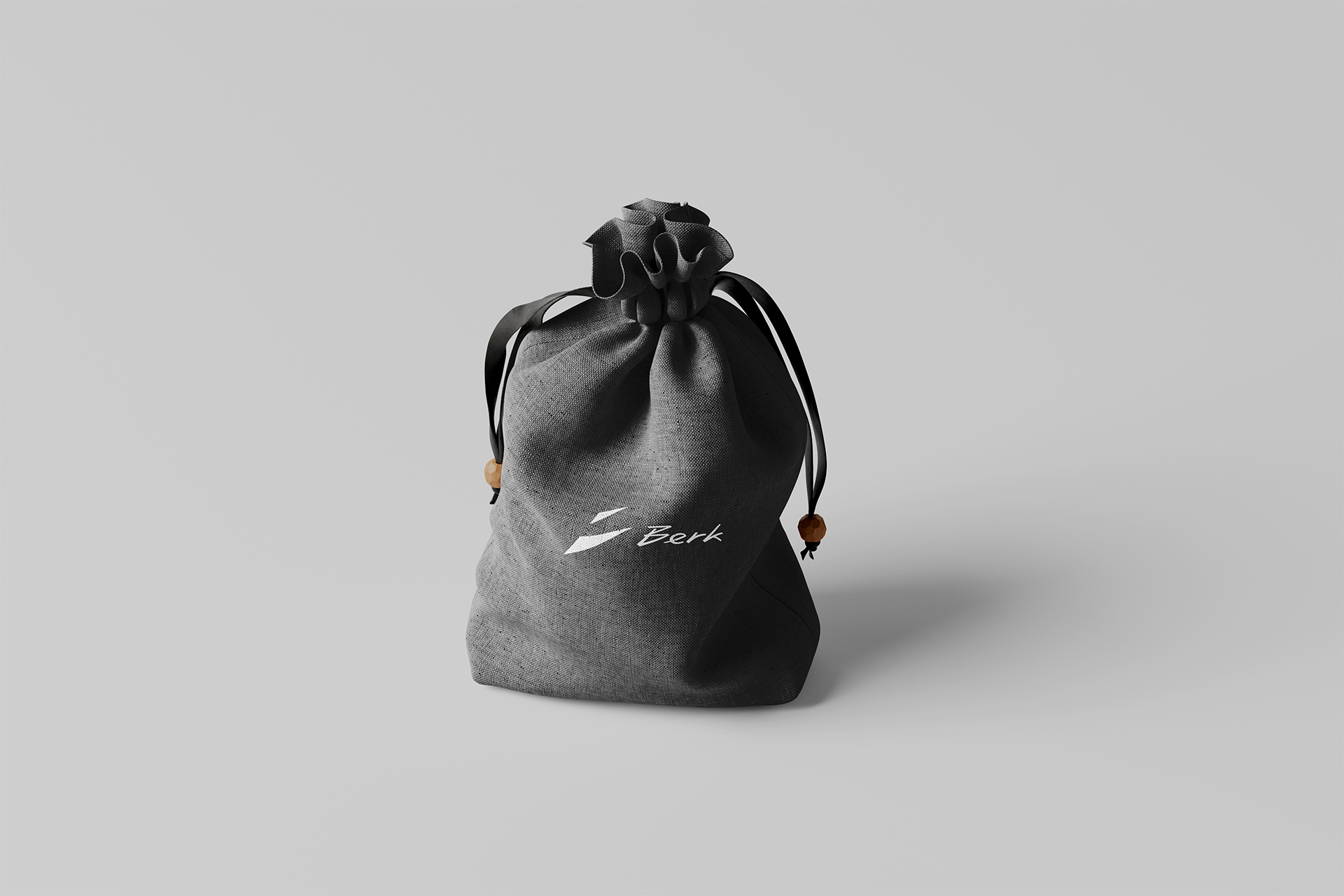 Black textile bag with drawstring and the white Berk logo printed at the centre of the bag.