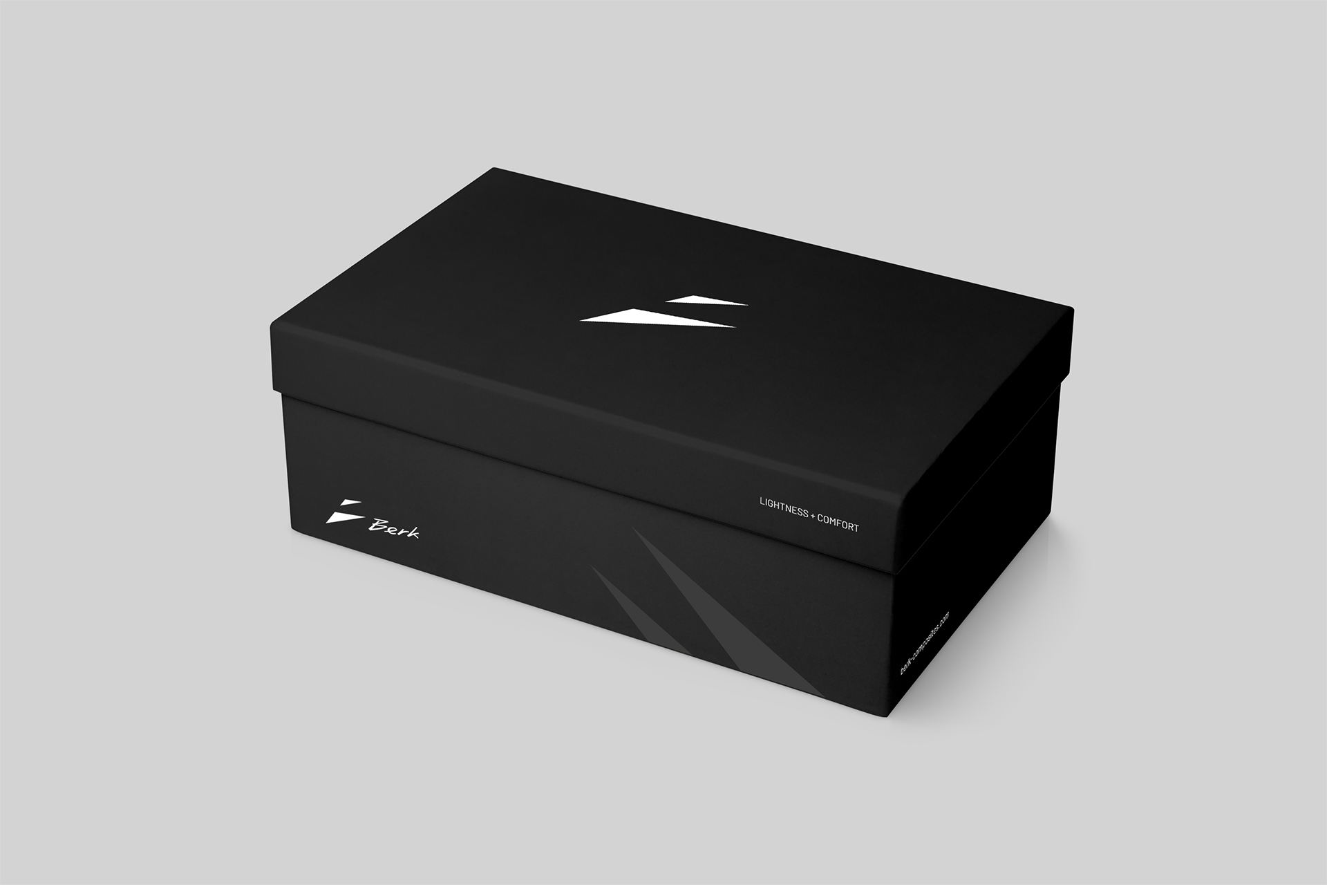 Minimalist black packaging for Berk Composites shoes featuring the new, sharp-edged logo design. The black box has clean white graphics.