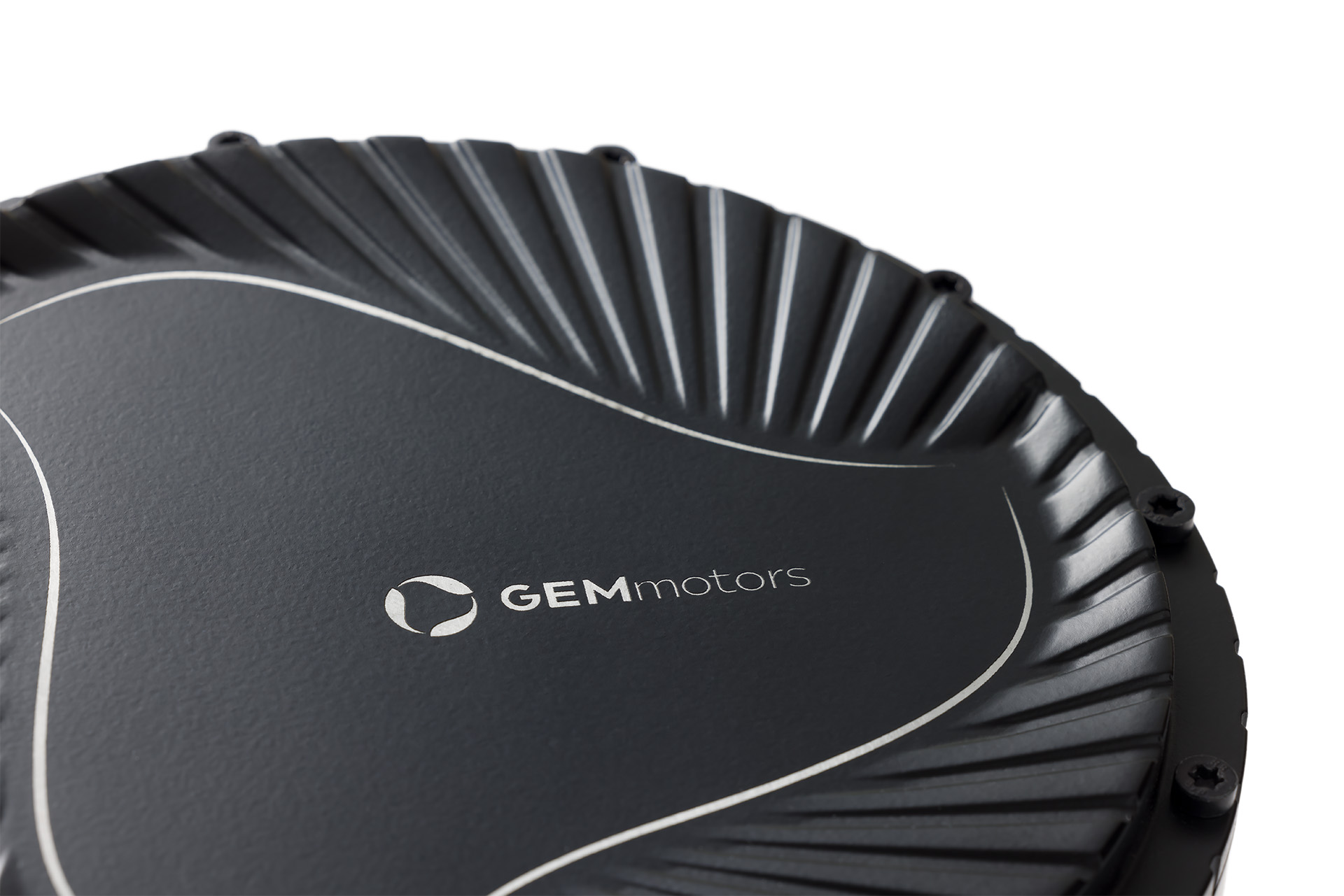 A closeup photo af a black gem motors in-wheel electric drive showing cooling ribs and mounting screws.