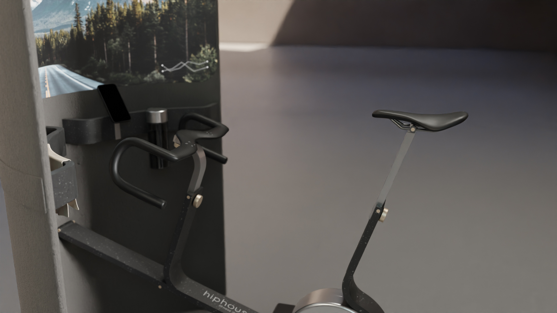 Close-up of a modern indoor spin bike in a minimalist workout space. The bike features sleek black handlebars and a slim saddle. A mounted screen in the background displays a forest road and elevation graph, suggesting a virtual cycling experience. The environment is clean and softly lit, with a smooth grey floor and neutral walls.