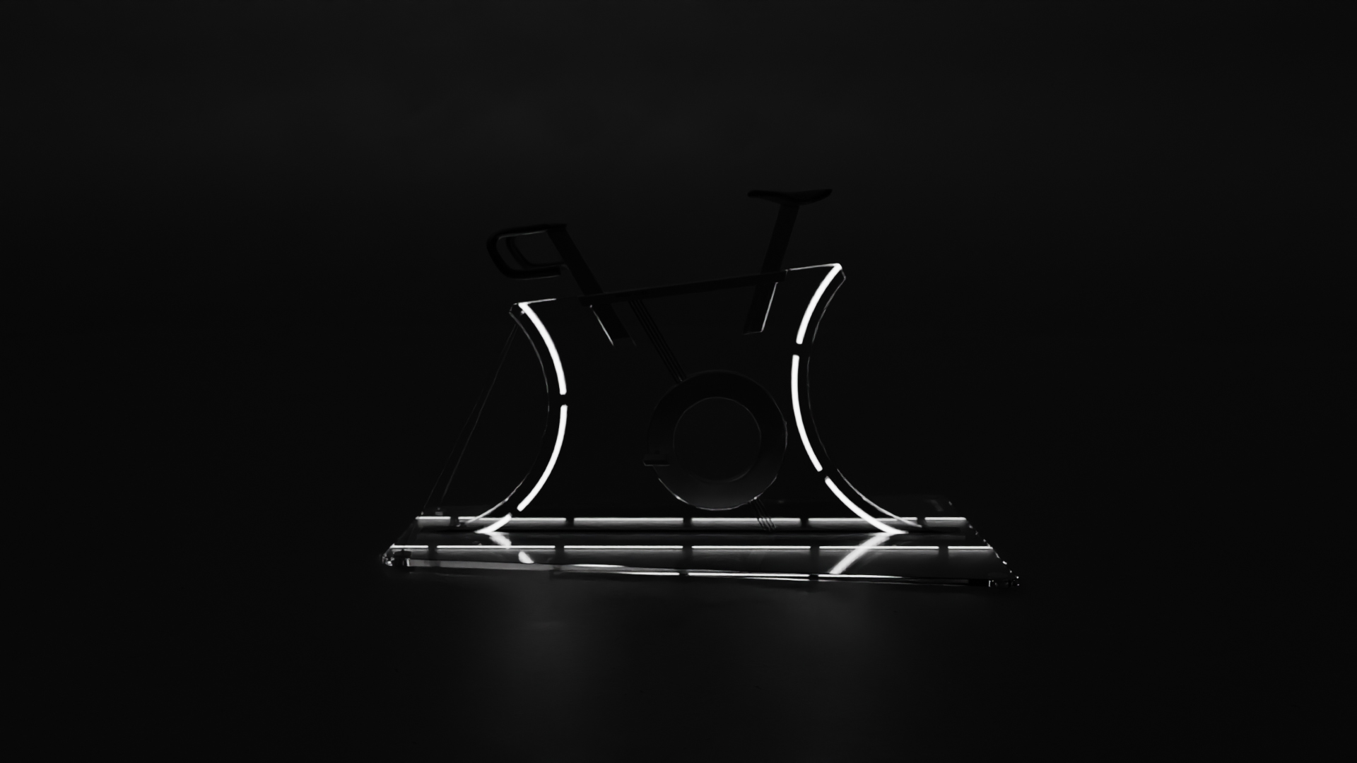 Side view of a futuristic indoor bike featuring a transparent glass panel frame with integrated linear lights, a circular central mechanism, and minimalist black handlebars and saddle, positioned in a dark room, emphasising the lights.